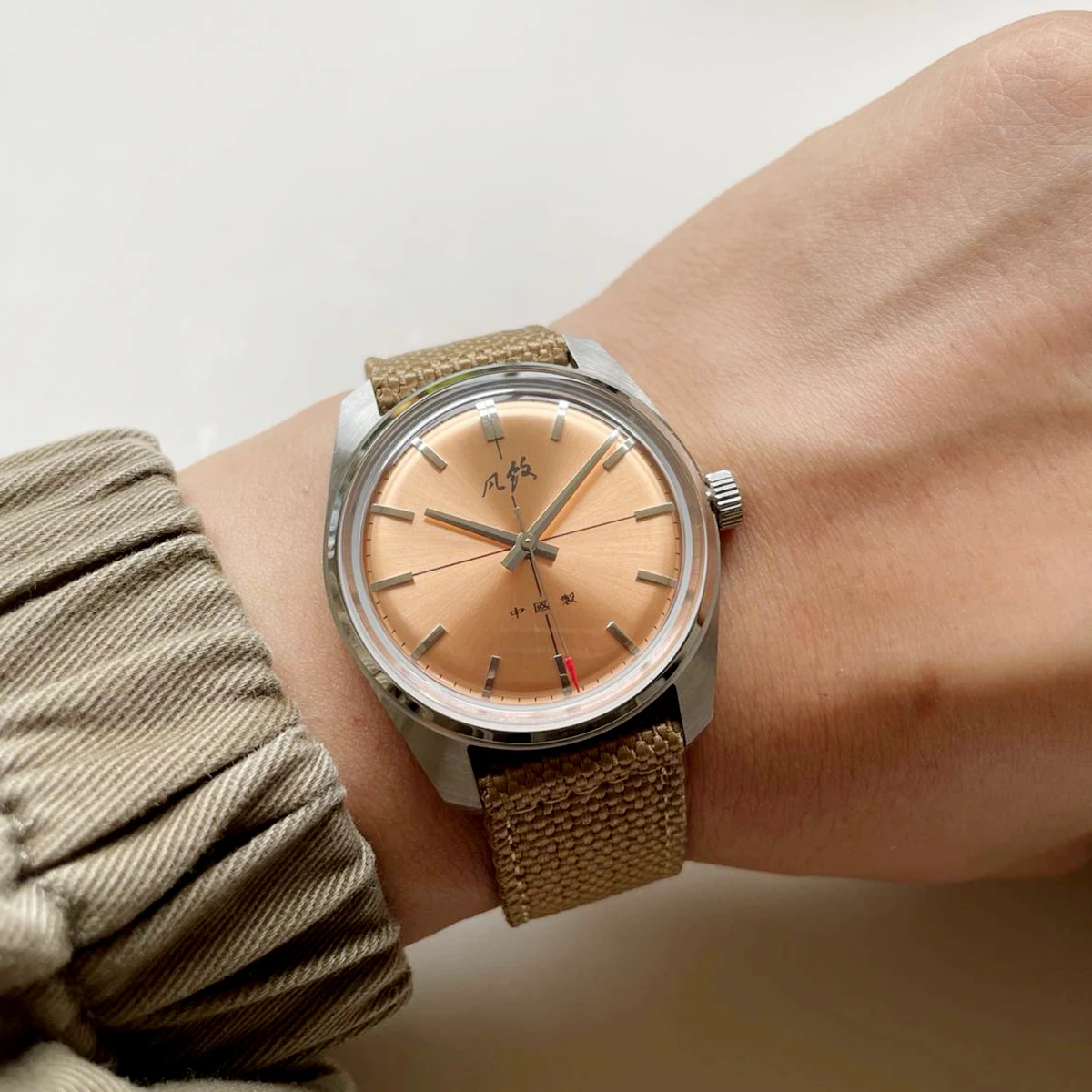 Classic salmon dial mechanical watch with elegant design principles shared with moonphase watches