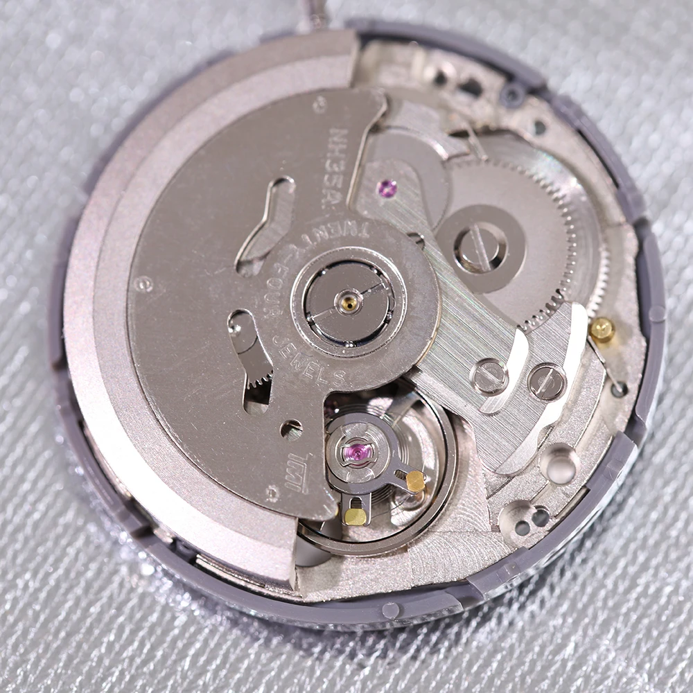 Close-up of an NH35 automatic movement with day-date function showing the 24 jewels
